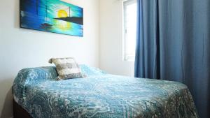 a bedroom with a bed with a pillow and a window at Bungalows Huerta del Mar in San Blas +28 photos