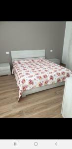 a bedroom with a bed with a floral comforter at Caruso'S House1 in Syracuse