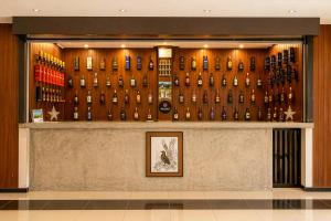 a display of bottles of wine on a wall at Sorabora Gedara Hotel in Mahiyangana