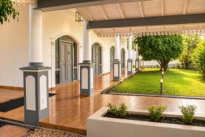 a courtyard of a house with a yard at Sorabora Gedara Hotel in Mahiyangana