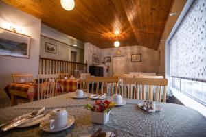 a dining room with a table with plates and utensils at Kerrigan's B&B in Mullingar