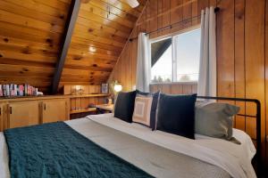 a bedroom with a large bed with a window at Big Bear Bungalow #643 in Big Bear City