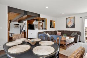 a living room with a table and chairs at Big Bear Bungalow #643 in Big Bear City