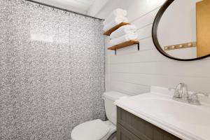 a bathroom with a toilet and a mirror at Big Bear Bungalow #643 in Big Bear City +21 photos