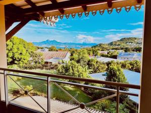 a view from the balcony of a house at Évasion Tropicale - vue et plage à 2 min in Les Trois-Îlets