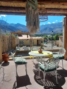 a table and chairs on a patio with a view at 4 ELEMENTOS in Huacalera