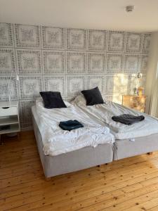 a bedroom with a bed with two towels on it at Smedjan Bed and Breakfast in Varberg