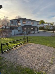 a building with a fence in front of it at Smedjan Bed and Breakfast in Varberg