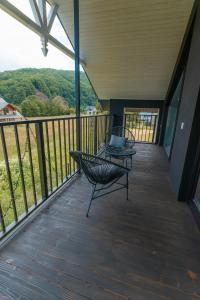 a balcony with a chair and a table on it at Yaremche Soul House in Yaremche