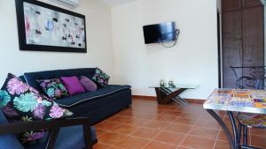 a living room with a couch and a table at Bungalows Huerta del Mar in San Blas