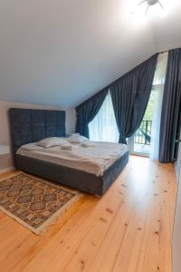 a bedroom with a bed and a wooden floor at Yaremche Soul House in Yaremche