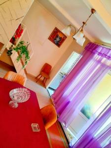 a living room with a red table and a window at Green House in Kobuleti