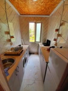 a small bathroom with a sink and a washing machine at Green House in Kobuleti