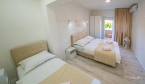 a bedroom with two beds and a window at Apartments Elle in Čitluk +98 photos