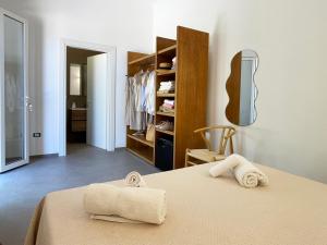a bedroom with a bed with two towels on it at Dimora Thalèa - Retreat & Rooms in Nardò +50 photos