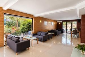 a large living room with couches and tables and windows at Family Hotel Kosko in Chernomorets +63 photos