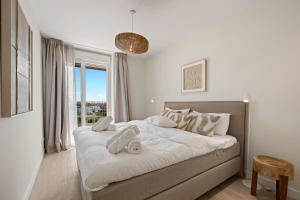a white bedroom with a large bed with white pillows at Casa Costa Xàbia in Jávea +14 photos