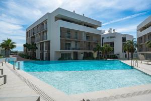 a swimming pool in front of a building at Casa Costa Xàbia in Jávea