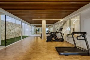 a gym with two exercise bikes and a treadmill at Casa Costa Xàbia in Jávea
