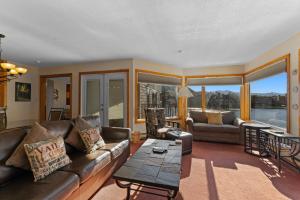 a living room with a couch and a table at Willows #1713 in Keystone