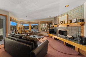 a living room with a couch and a fireplace at Willows #1713 in Keystone