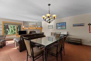 a living room with a table and chairs and a couch at Willows #1713 in Keystone