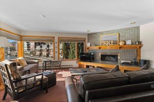 a living room with a couch and a fireplace at Willows #1713 in Keystone