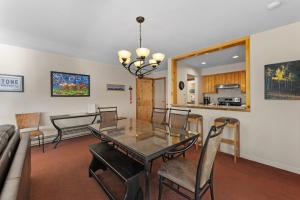 a dining room and living room with a table and chairs at Willows #1713 in Keystone +24 photos