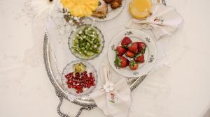 a table topped with plates of food and fruit at Villa del Gattopardo in Palermo