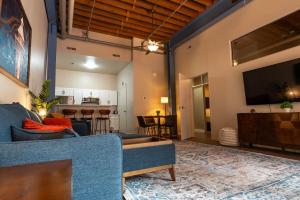 a living room with a couch and a flat screen tv at The Inn Down Town in Erie