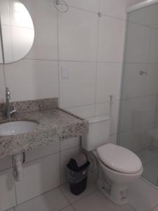 a bathroom with a toilet and a sink and a mirror at Pousada Valente in Barreirinhas +12 photos