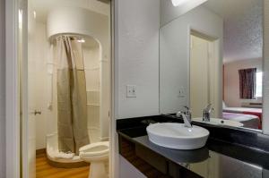 a bathroom with a sink and a toilet and a mirror at Motel 6-Salina, KS in Salina