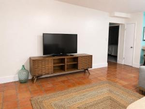 a living room with a flat screen tv on a entertainment center at East End Escape in Christiansted