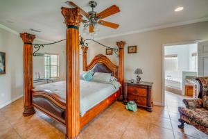 a bedroom with a wooden canopy bed and a couch at Red Oak Group Getaway w/ Yard + Patio in Red Oak