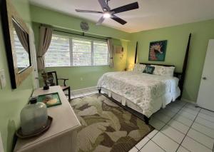 a bedroom with a bed and a ceiling fan at East End Escape in Christiansted +9 photos