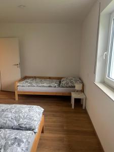 a room with two beds and a table in it at Ferienwohnung Landhege in Michelfeld