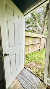 an open door with a view of a fence at Flawless one bedroom apartment! in Houston +2 photos