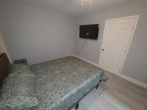 a bedroom with a bed and a flat screen tv at Flawless one bedroom apartment! in Houston
