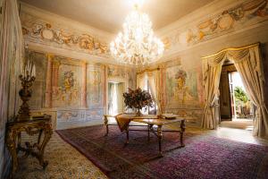 a large room with a table and a chandelier at Villa del Gattopardo in Palermo