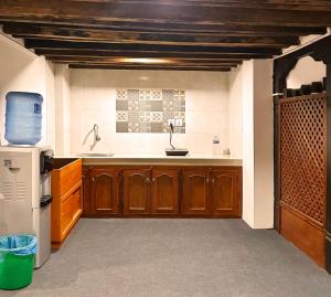 a kitchen with a sink and a refrigerator at Newa Inn Homestay in Kathmandu