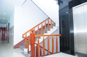 a staircase with wooden railings in a building at Gia Huy Guesthouse in Danang
