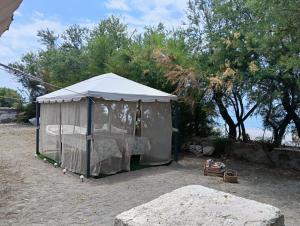 a white tent with a bed in it at B&B Sulla Spiaggia in Belmonte Calabro