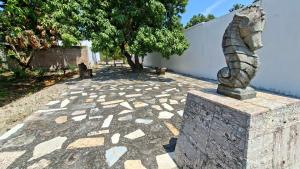 a statue of a fish on a stone block at Bungalows Huerta del Mar in San Blas