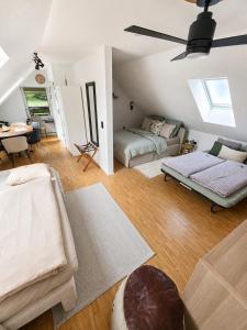 a living room with two beds and a couch at All Homes Apartments Bad Schallerbach in Bad Schallerbach