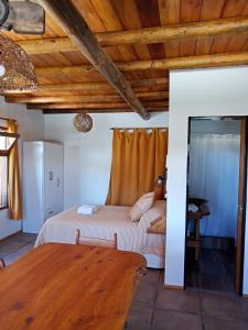 a bedroom with a bed and a wooden ceiling at Cabañas Luna Lunera in Tandil +33 photos