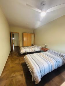 a bedroom with two beds and a ceiling fan at Casa La Fuente in Chella