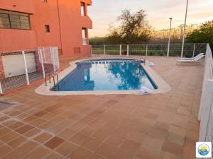a swimming pool on a patio next to a building at Adosado Primera línea de mar Playa de Puzol con Piscina y terrazas in Playa de Mar