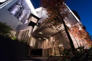 a building with a clock on the side of it at ホテル ゼン町田 in Machida