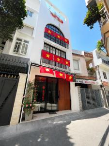 a building with a store with chinese signs on it at Cỏ Lá Homestay in Danang