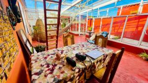 a room with a table with a laptop on it at Casa Nazimova Indigo Room in San Cristóbal de Las Casas